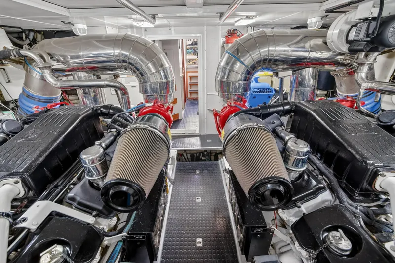Slide: The Image of Engine room of 2009 Horizon Flybridge yacht with dual engines and polished exhaust pipes. - 34