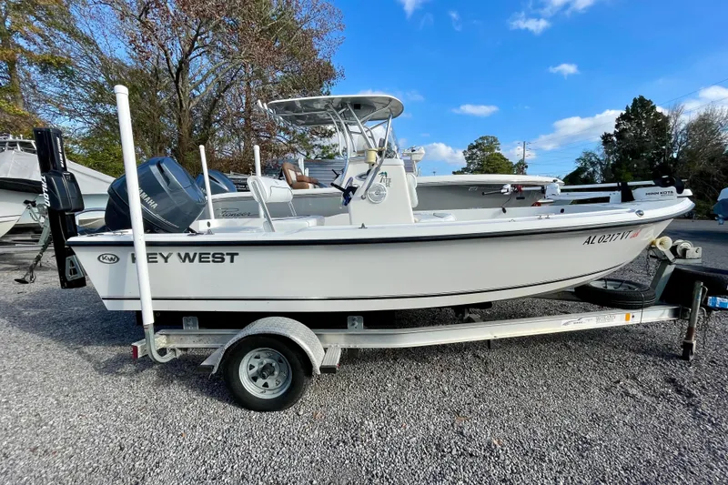 Slide: The Image of 2013 Key West 172 SE boat on trailer, parked outdoors under blue sky. - 1