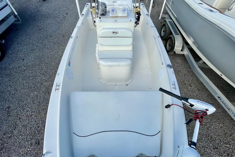 Slide: The Image of 2013 Key West 172 SE boat interior with seating and controls, parked on gravel. - 10