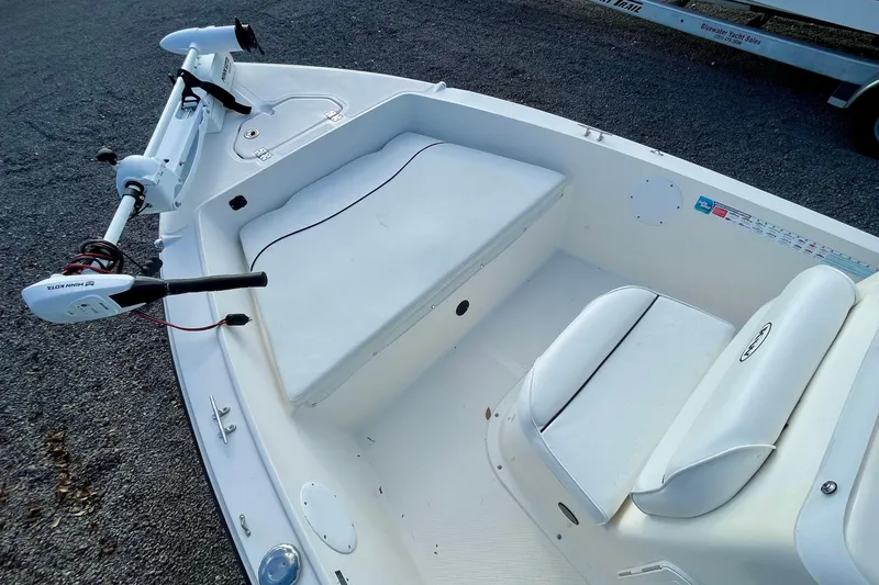 Slide: The Image of 2013 Key West 172 SE boat interior with white seating and trolling motor. - 11