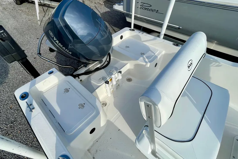 Slide: The Image of 2013 Key West 172 SE boat interior with Yamaha engine, featuring seating and storage compartments. - 15