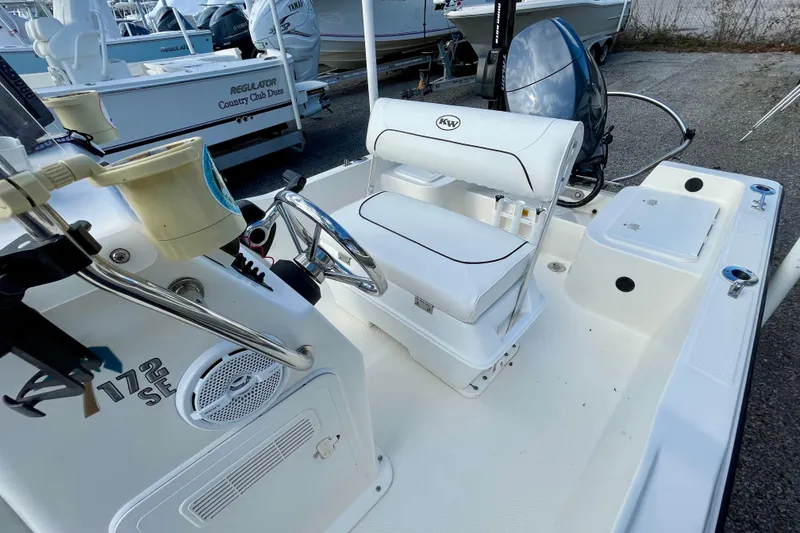 Slide: The Image of 2013 Key West 172 SE boat interior with steering wheel and seating. - 16