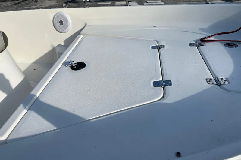 Slide: The Image of 2022 Key West 1720 Sportsman boat deck with storage compartments and speaker. - 13