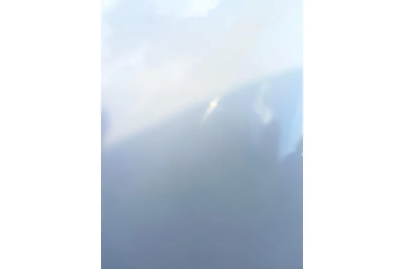 Slide: The Image of Blurry image with light blue and white hues, possibly sky or water reflection. - 14