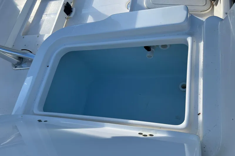 Slide: The Image of Livewell compartment on a 2022 Key West 1720 Sportsman boat, open and empty. - 21