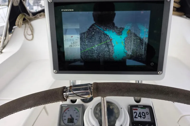 Slide: The Image of Furuno chart plotter and Raymarine wind and autopilot instruments on binnacle - 12