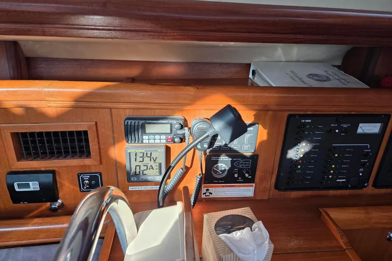 Slide: The Image of Hunter 44DS nav station with battery and tank monitoring, DC & AC panels, VHF, and Webasto heat control - 16