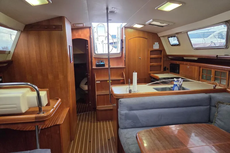 Slide: The Image of Luxurious interior of 2007 Hunter 44 Deck Salon yacht with wood finishes and modern amenities. - 2