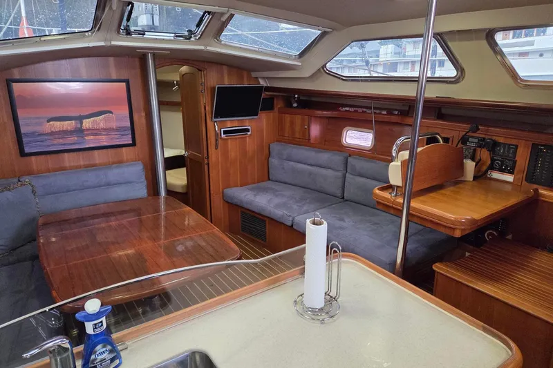 Slide: The Image of Interior of 2007 Hunter 44 Deck Salon yacht with cozy seating and wooden finishes. - 20