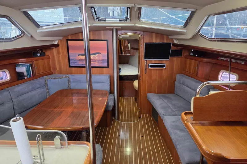 Slide: The Image of Luxurious 2007 Hunter 44 Deck Salon interior with wood finish and spacious seating. - 21