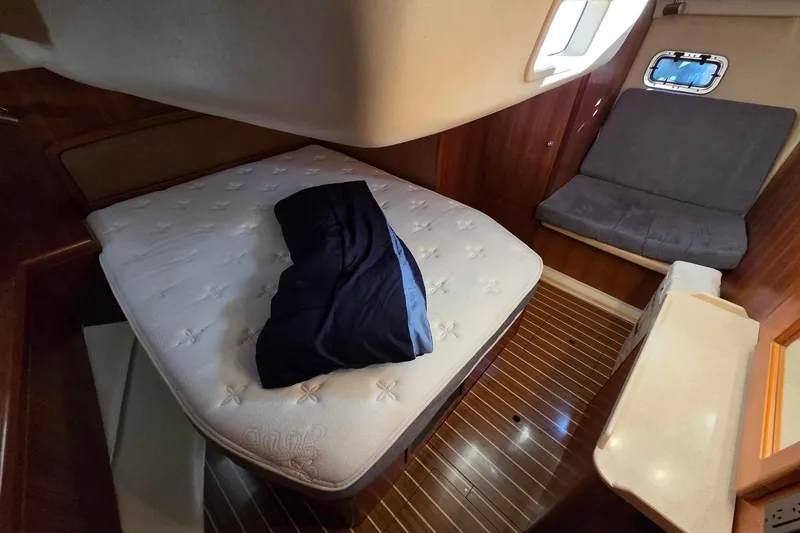Slide: The Image of Spacious aft queen berth with seating, counter, and mirror - 4