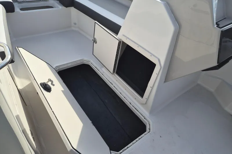 Slide: The Image of 2026 Starcraft SVX 191 OB boat interior storage compartments open. - 11
