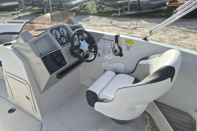Slide: The Image of 2026 Starcraft SVX 191 OB boat cockpit with steering wheel and control panel. - 5