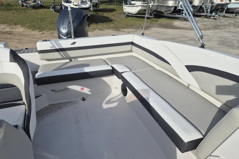 Slide: The Image of 2026 Starcraft SVX 191 OB boat interior with cushioned seating and outboard motor. - 7