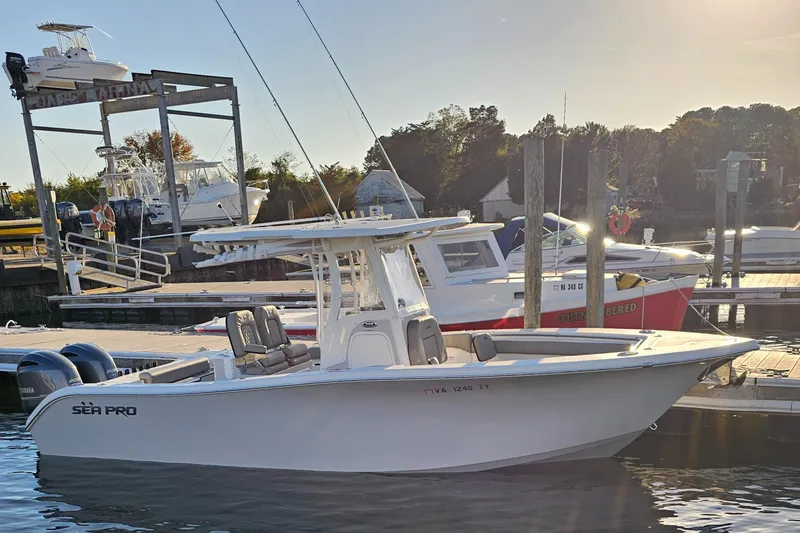 The Image of 2021 Sea Pro 259 Center Console boat docked at marina during sunset. - 0