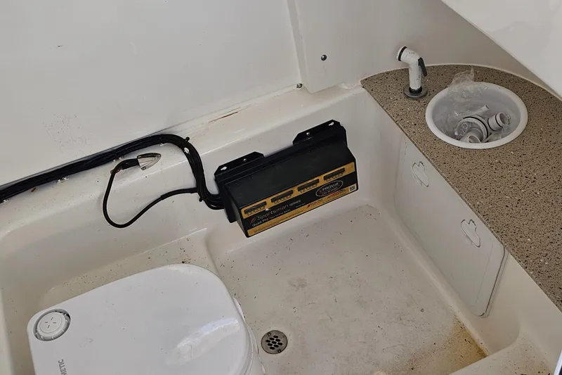 Slide: The Image of Interior of 2021 Sea Pro 259 Center Console boat with sink and storage. - 11