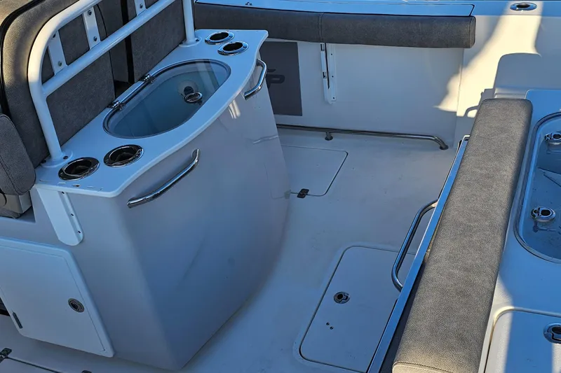 Slide: The Image of 2021 Sea Pro 259 Center Console boat interior with seating and storage. - 2