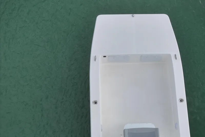 Slide: The Image of Bay Rider 2460 Skiff 2024 boat on calm green water, aerial view. - 10