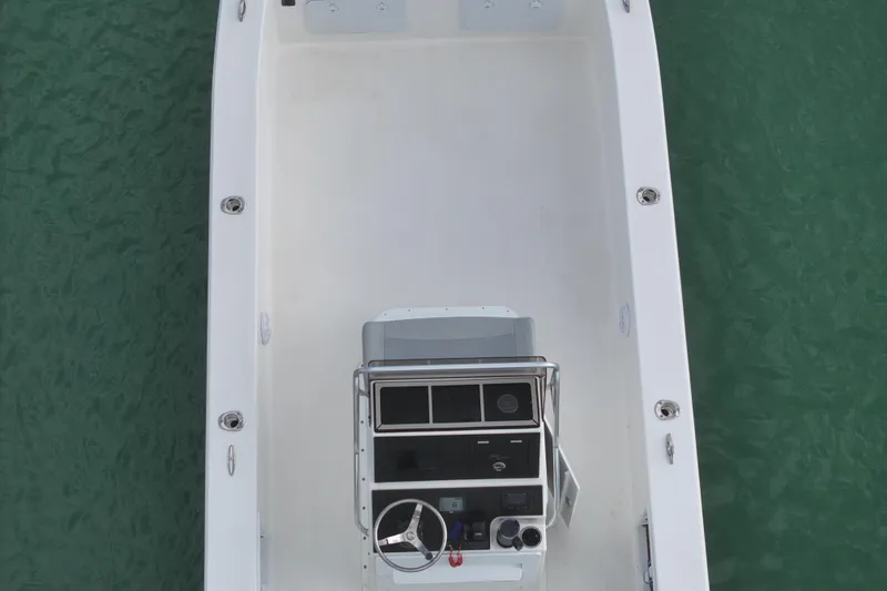 Slide: The Image of 2024 Bay Rider 2460 Skiff boat, aerial view, on green water. - 11