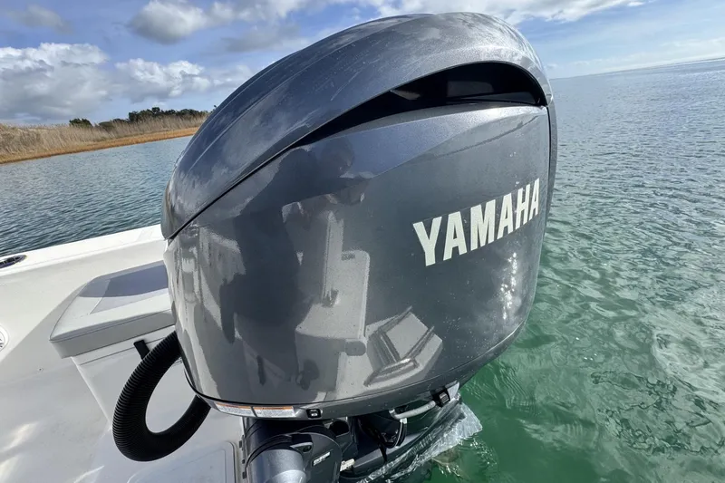 Slide: The Image of 2024 Bay Rider 2460 Skiff with Yamaha outboard motor on calm water. - 26