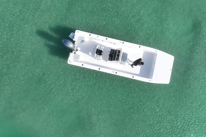 Slide: The Image of Aerial view of 2024 Bay Rider 2460 Skiff on clear turquoise water. - 28