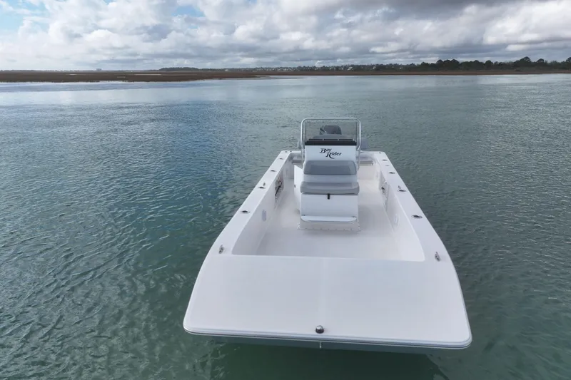 Slide: The Image of 2024 Bay Rider 2460 Skiff on calm water under cloudy sky. - 5