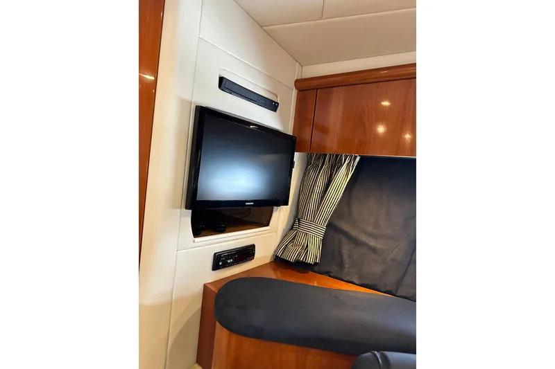 Slide: The Image of Interior of 2000 Sunseeker Predator 60 yacht with TV and wood paneling. - 101