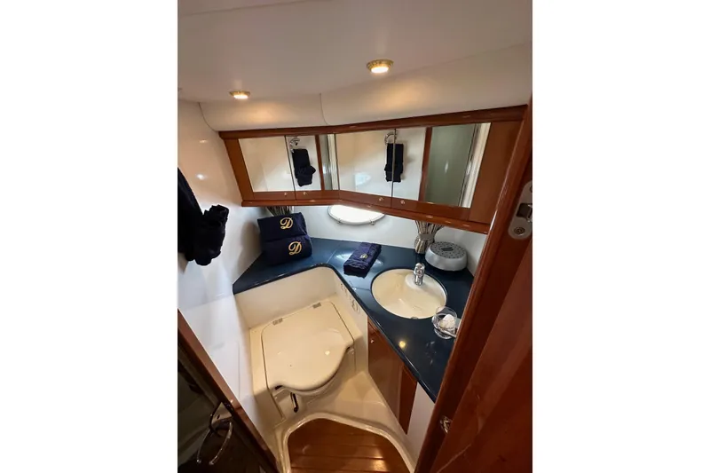 Slide: The Image of Luxurious bathroom in 2000 Sunseeker Predator 60 yacht with elegant fixtures and wood accents. - 103