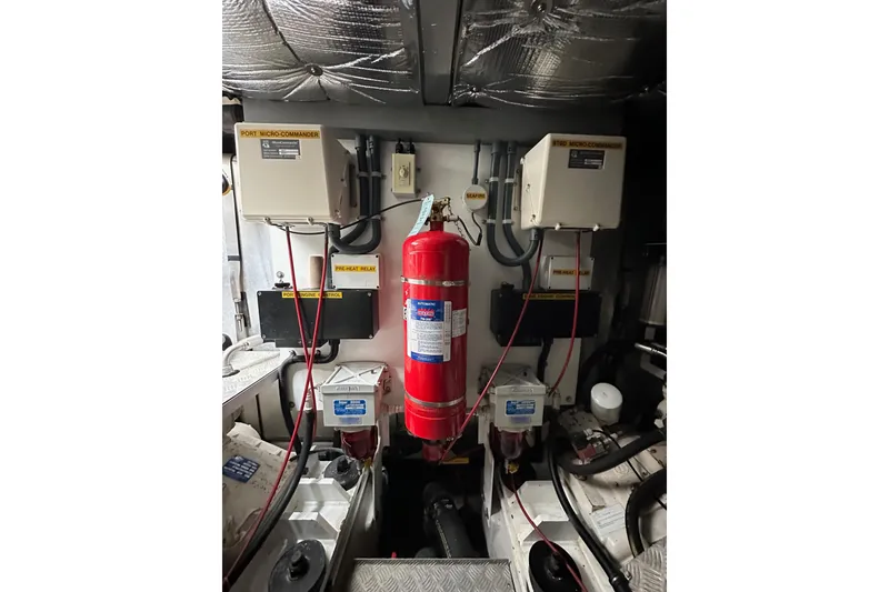 Slide: The Image of Engine room of 2000 Sunseeker Predator 60 with fire extinguisher and control panels. - 119