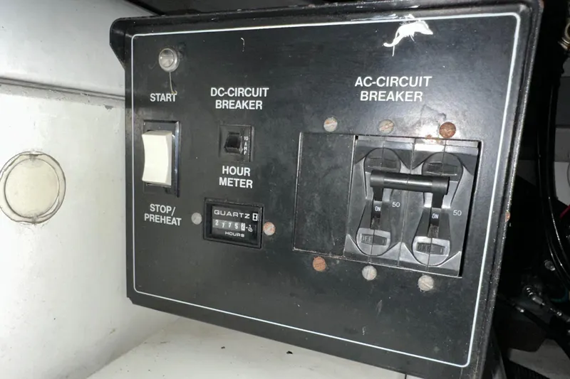 Slide: The Image of Control panel of a 2000 Sunseeker Predator 60 yacht with circuit breakers and hour meter. - 123