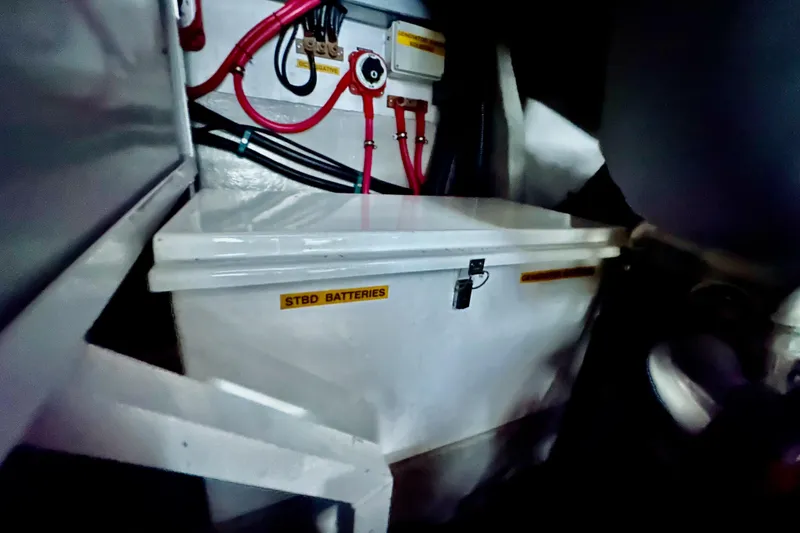 Slide: The Image of Battery compartment of 2000 Sunseeker Predator 60 yacht with labeled wiring and connections. - 129