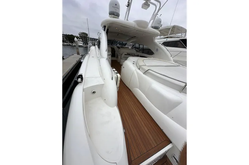 Slide: The Image of Sunseeker Predator 60 yacht, 2000 model, featuring sleek white design and wooden deck. - 14