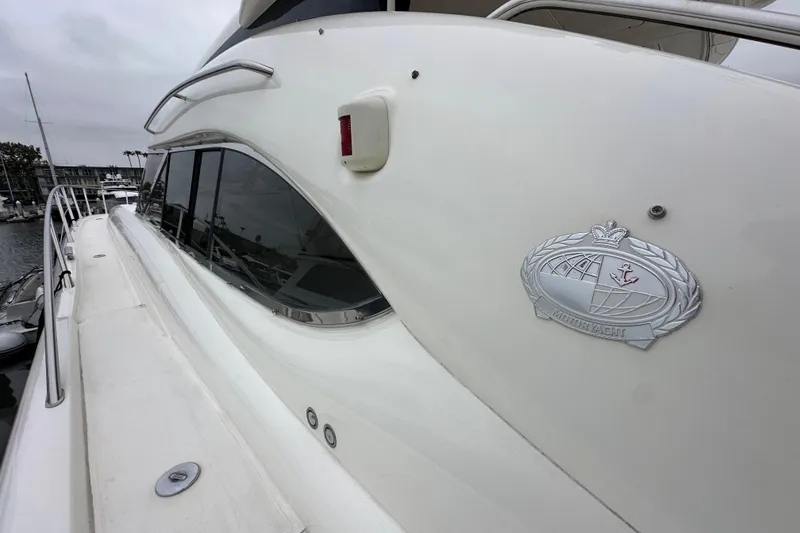 Slide: The Image of Side view of a 2000 Sunseeker Predator 60 yacht with emblem detail. - 17