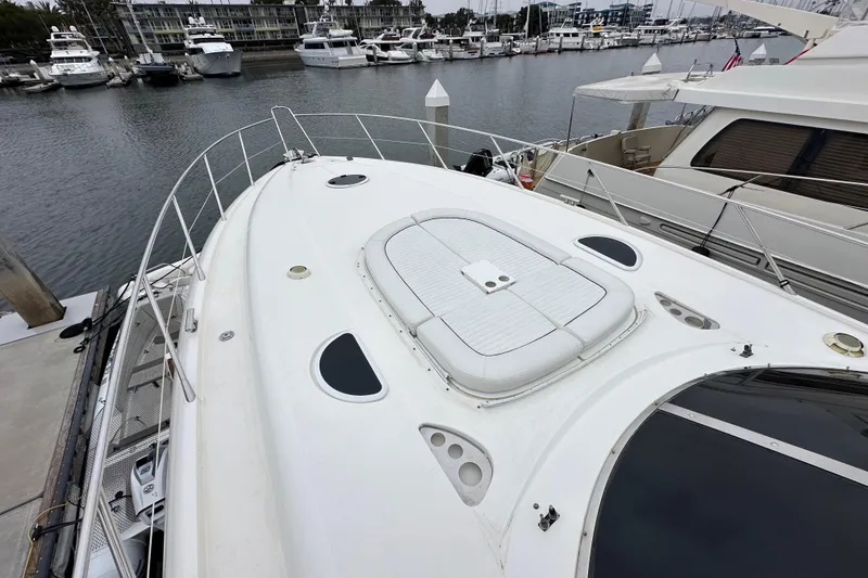 Slide: The Image of Sunseeker Predator 60 yacht, 2000 model, docked in a marina with other boats. - 19