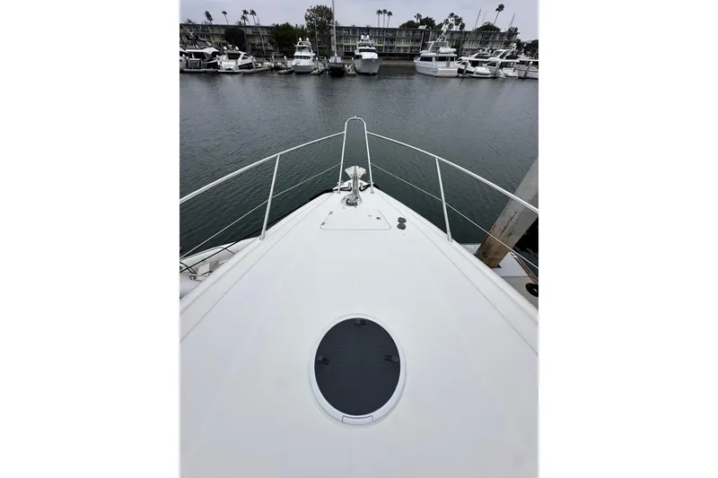 Slide: The Image of Bow view of 2000 Sunseeker Predator 60 yacht docked in a marina. - 21