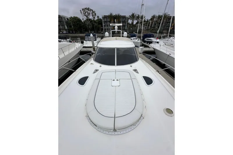 Slide: The Image of Sunseeker Predator 60 yacht, 2000 model, docked in a marina with surrounding boats. - 25