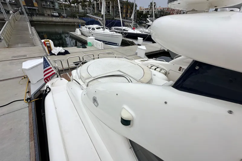 Slide: The Image of Sunseeker Predator 60 yacht docked at marina, rear view, American flag displayed. - 28