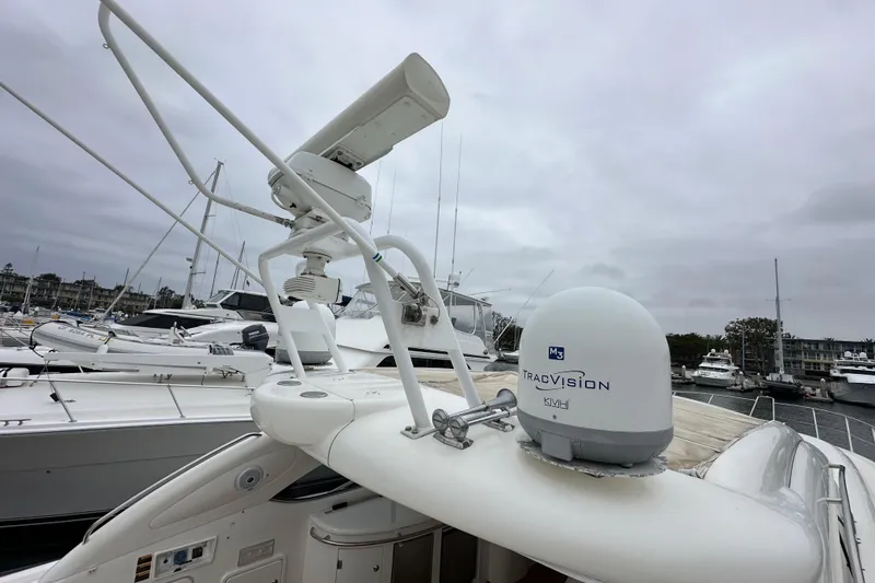Slide: The Image of Sunseeker Predator 60 yacht, 2000 model, featuring TracVision satellite system in a marina setting. - 29