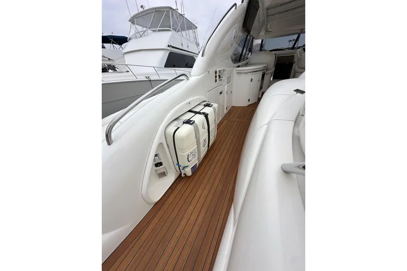 Slide: The Image of Sunseeker Predator 60 yacht deck, 2000 model, featuring sleek design and wooden flooring. - 31