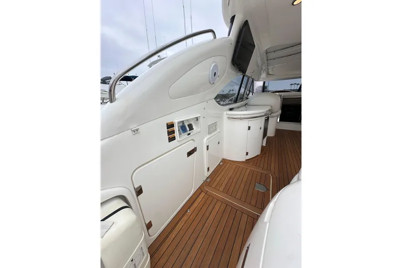 Slide: The Image of Sunseeker Predator 60 yacht interior, 2000 model, featuring sleek white design and wooden flooring. - 32
