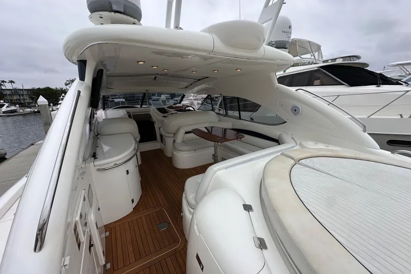 Slide: The Image of Luxurious 2000 Sunseeker Predator 60 yacht interior with sleek white seating and wooden flooring. - 33