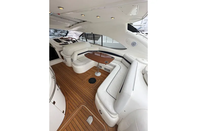Slide: The Image of Luxurious interior of a 2000 Sunseeker Predator 60 yacht with elegant seating and wooden flooring. - 35