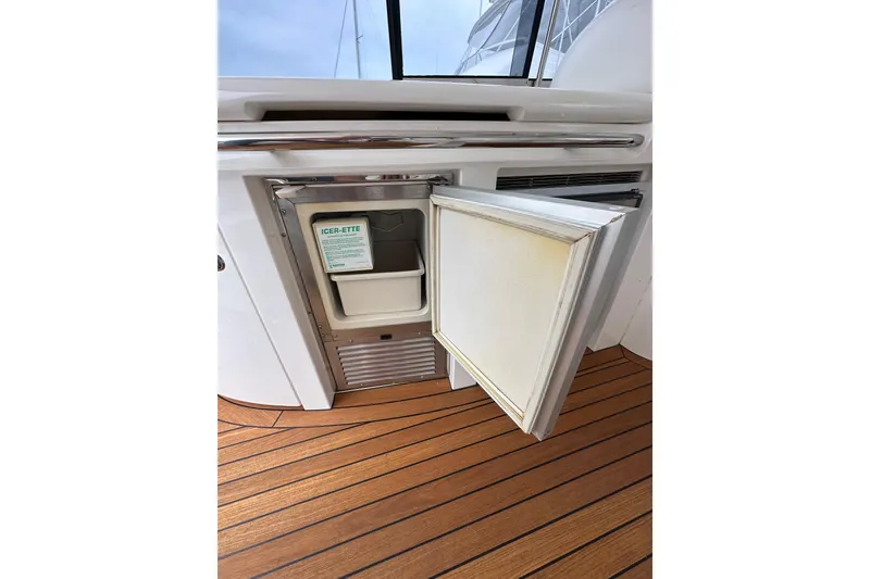 Slide: The Image of Sunseeker Predator 60 yacht, 2000 model, featuring an open ice maker on teak flooring. - 37