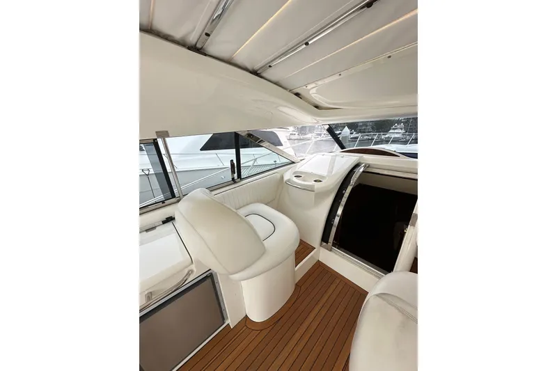 Slide: The Image of Interior of 2000 Sunseeker Predator 60 yacht with white seating and wooden flooring. - 41