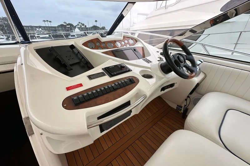 Slide: The Image of Cockpit of 2000 Sunseeker Predator 60 yacht with steering wheel and control panel. - 42