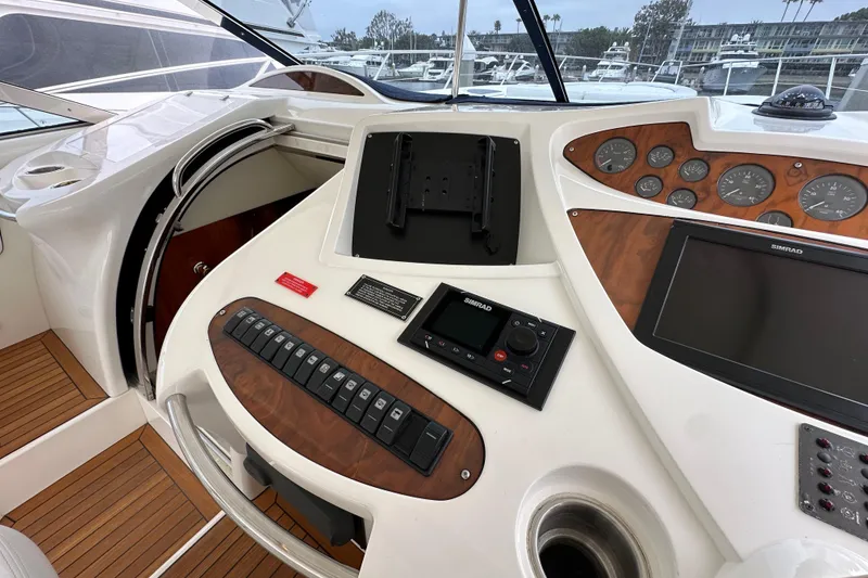 Slide: The Image of Cockpit of 2000 Sunseeker Predator 60 yacht with navigation controls and dashboard. - 49