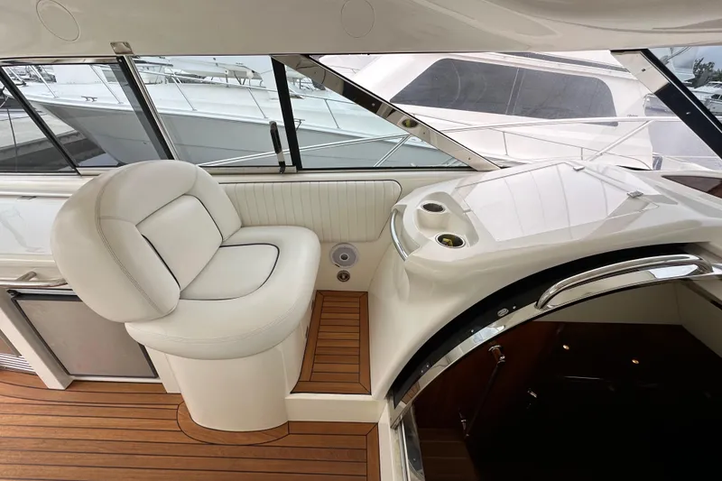 Slide: The Image of Luxurious interior of 2000 Sunseeker Predator 60 yacht with white seating and wooden flooring. - 50