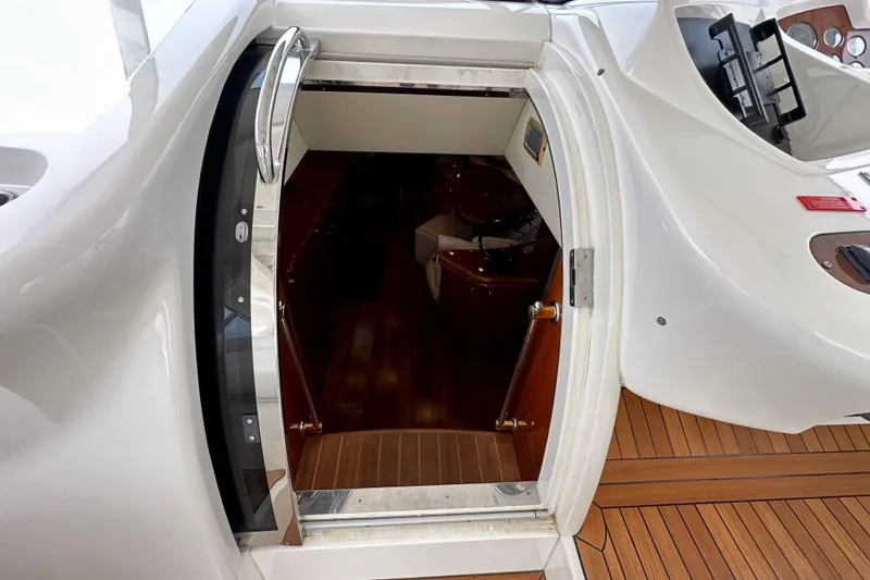 Slide: The Image of Entrance to cabin of 2000 Sunseeker Predator 60 yacht, featuring sleek design and wooden flooring. - 51