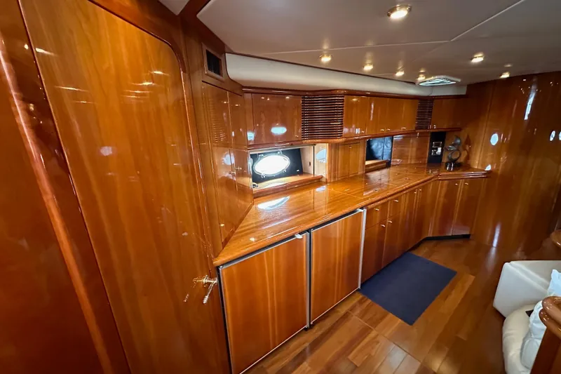 Slide: The Image of Luxurious wooden interior of 2000 Sunseeker Predator 60 yacht, featuring sleek cabinetry and ambient lighting. - 54