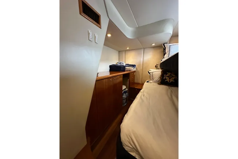 Slide: The Image of Interior cabin of 2000 Sunseeker Predator 60 yacht with wooden cabinetry and bedding. - 59